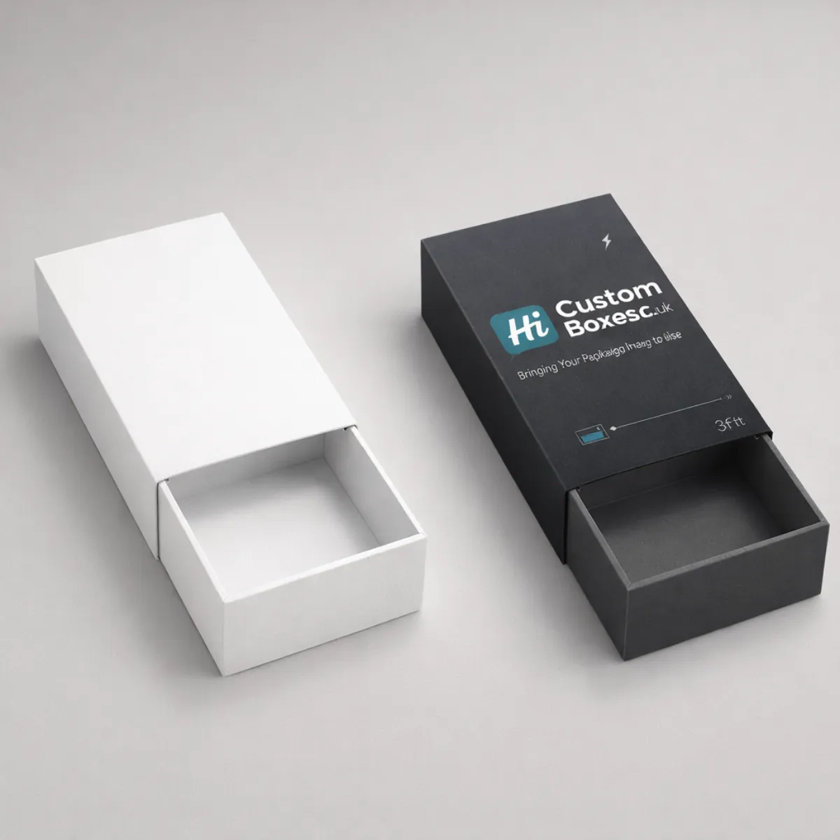 Two sliding drawer-style boxes; one plain white and one black with a teal company logo. class=